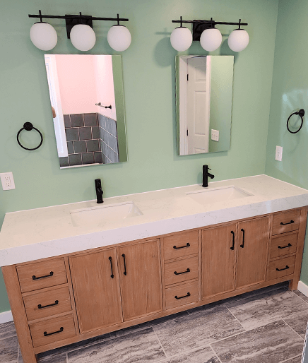 A bathroom with two sinks and mirrors.