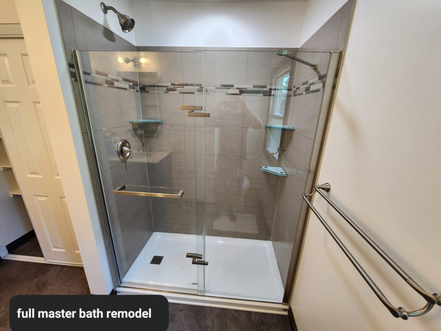 A bathroom with a shower and tiled walls.