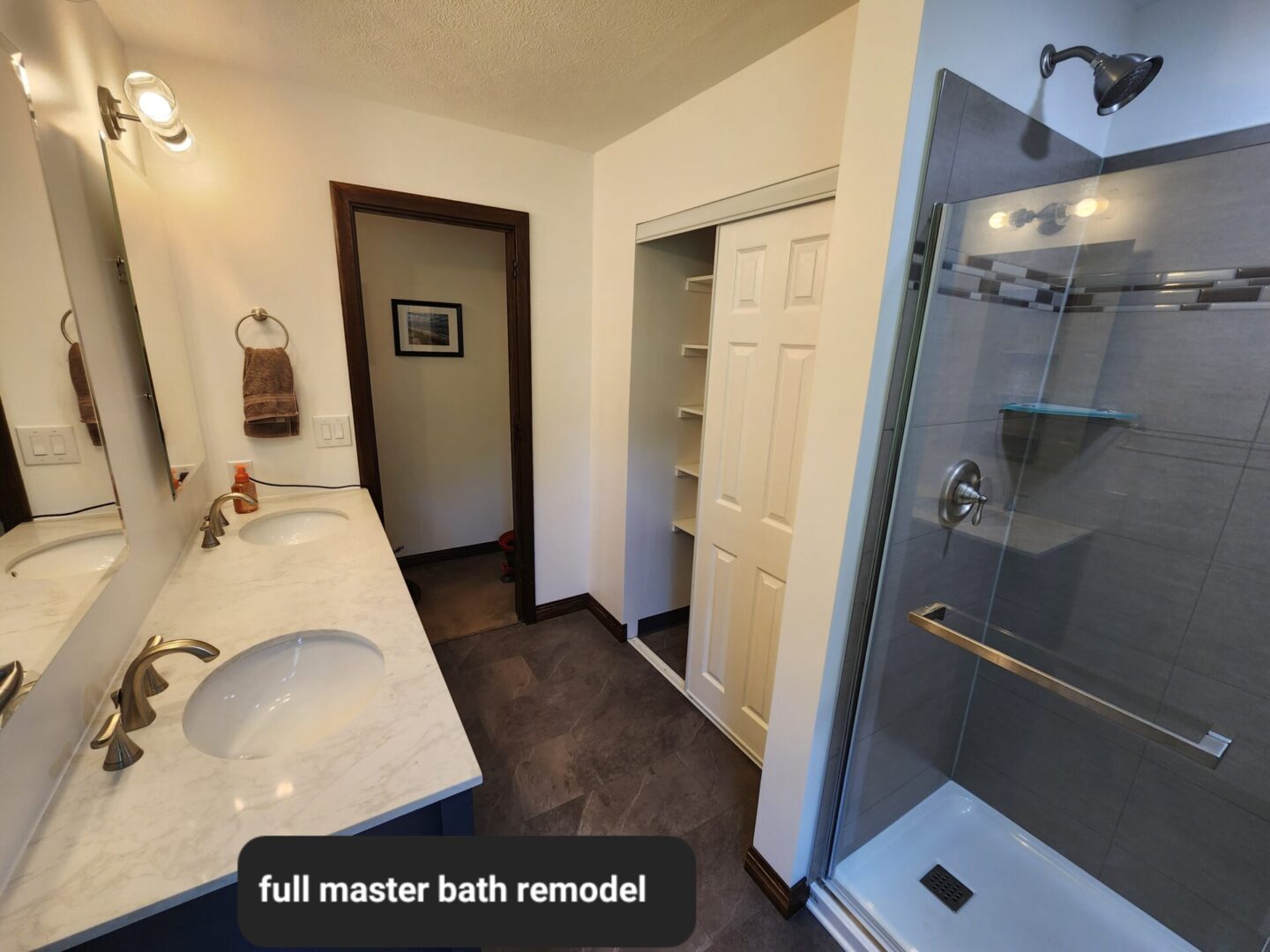 A bathroom with a large sink and walk in shower.