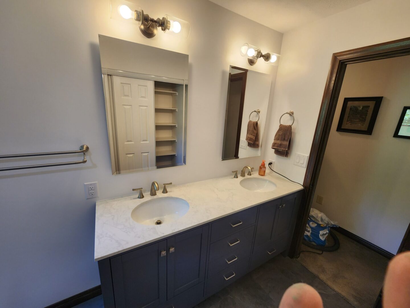 A bathroom with two sinks and a mirror.