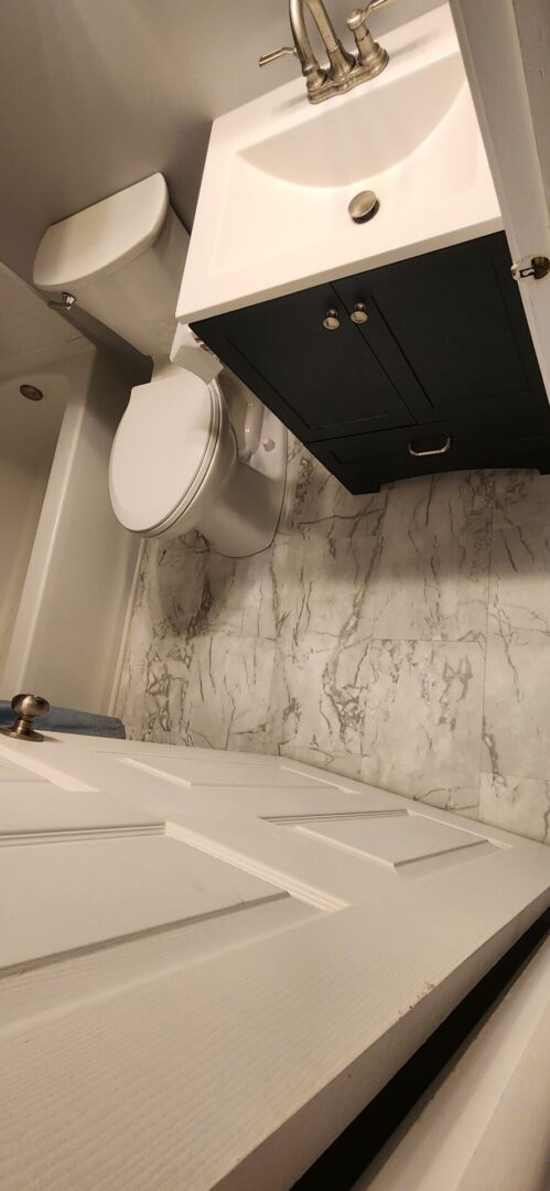 A bathroom with marble walls and floors.