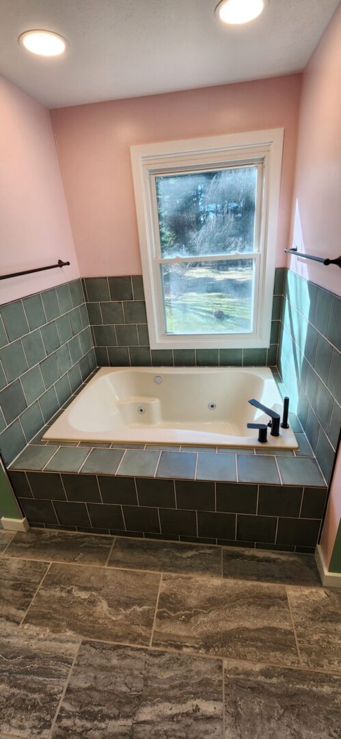 A bathroom with a tub and window in it