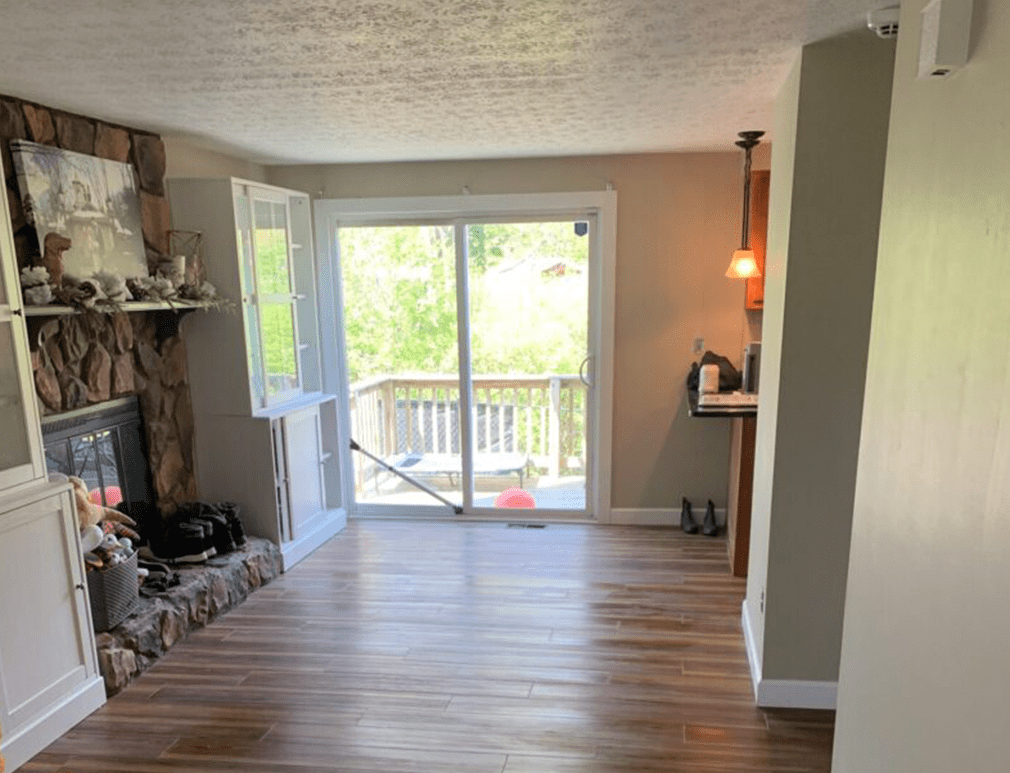 A living room with hardwood floors and sliding glass doors.