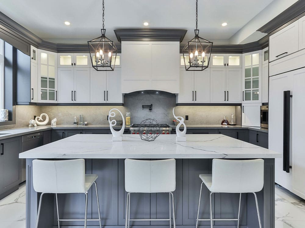 A kitchen with white cabinets and black accents